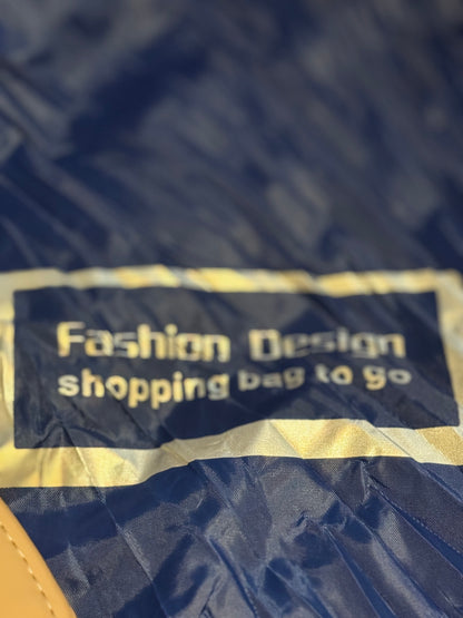 Blue shopping bag with 'Fashion Design shopping bag to go' text on a blue background
