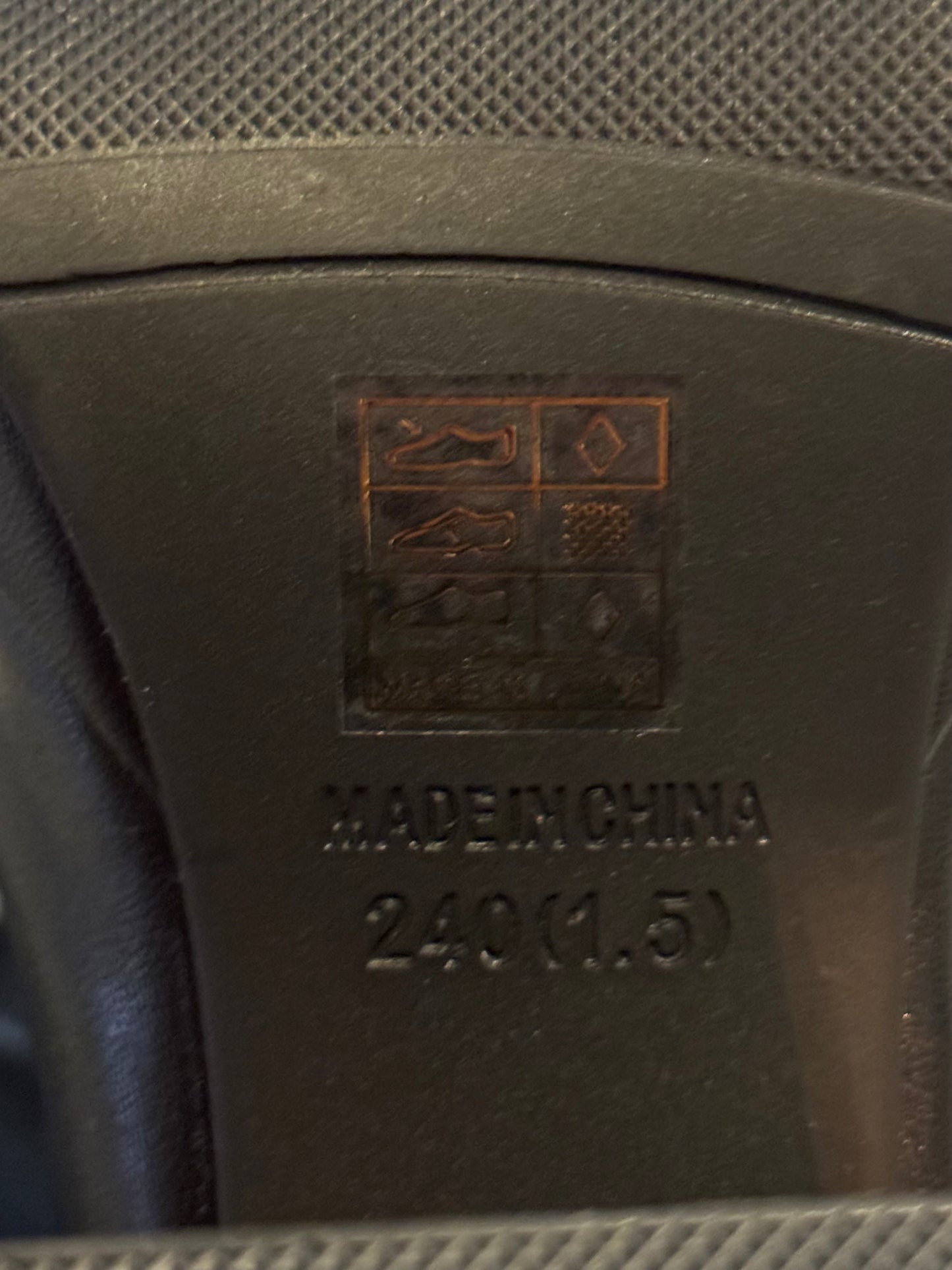 Text and logo on a brown leather product with 'Made in China' and size information.
