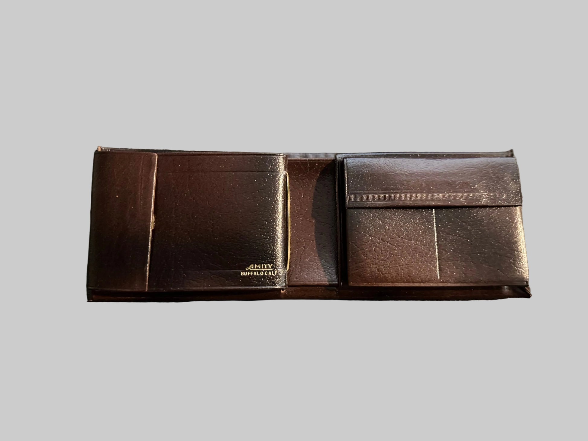 Brown leather belt with a visible brand name on a textured fabric background