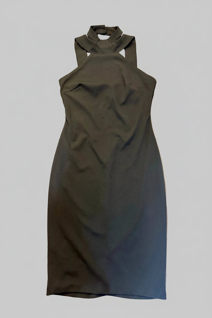 A sleeveless black midi dress with a mock neck and cutout details, laid flat on a dark wooden tiled floor.