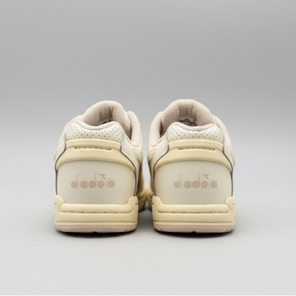 Pair of beige sneakers with 'Diadora' branding on a light gray background