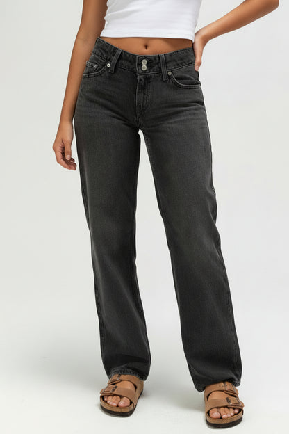 Person wearing black jeans on a white background