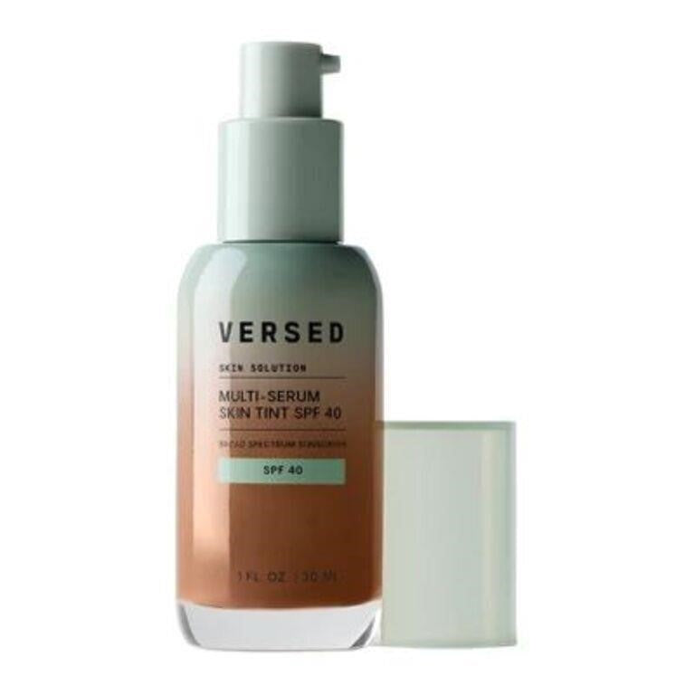 A bottle of VERSED Skin Solution Multi-Serum Skin Tint SPF 40 with its cap removed and standing beside it on a plain white background.