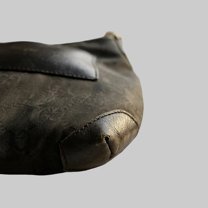 Black leather pouch on a marble surface with gold accents
