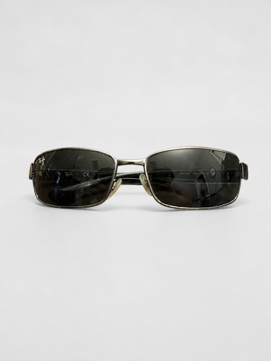 A pair of square metal-framed sunglasses with dark tinted lenses, displayed horizontally on a light gray background.