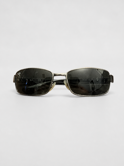A pair of square metal-framed sunglasses with dark tinted lenses, displayed horizontally on a light gray background.