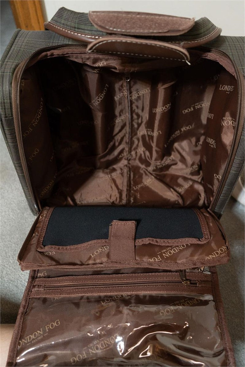 An open brown London Fog toiletry bag showing its interior compartments, including a zippered main section, a dark blue insert pocket, and a clear plastic pouch at the bottom.