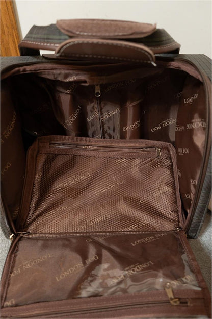 An open brown leather or faux-leather bag showing the interior compartments, mesh pockets, and branded lining. The lining has a repeating 'LONDON FOX' pattern.