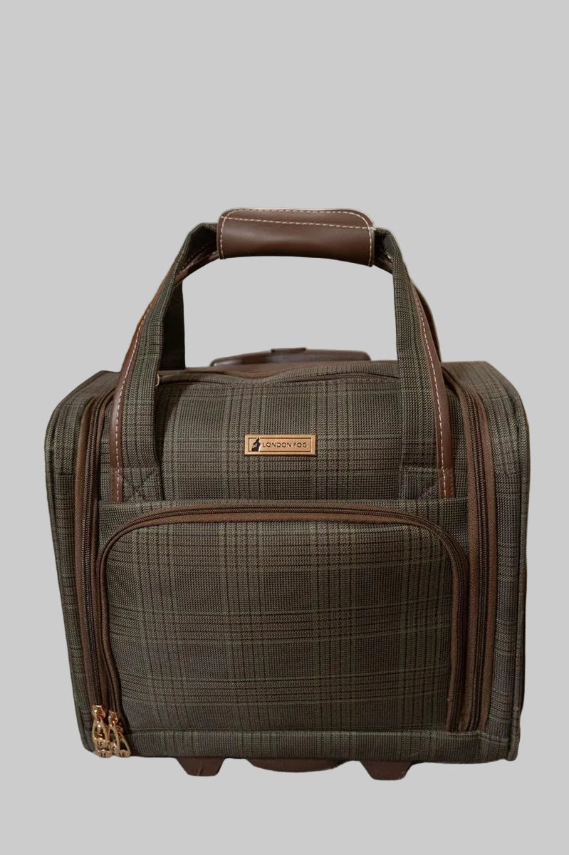 A plaid rolling duffel bag in dark brown and gray with brown leather handles, standing on a gray carpeted floor against a beige wall.