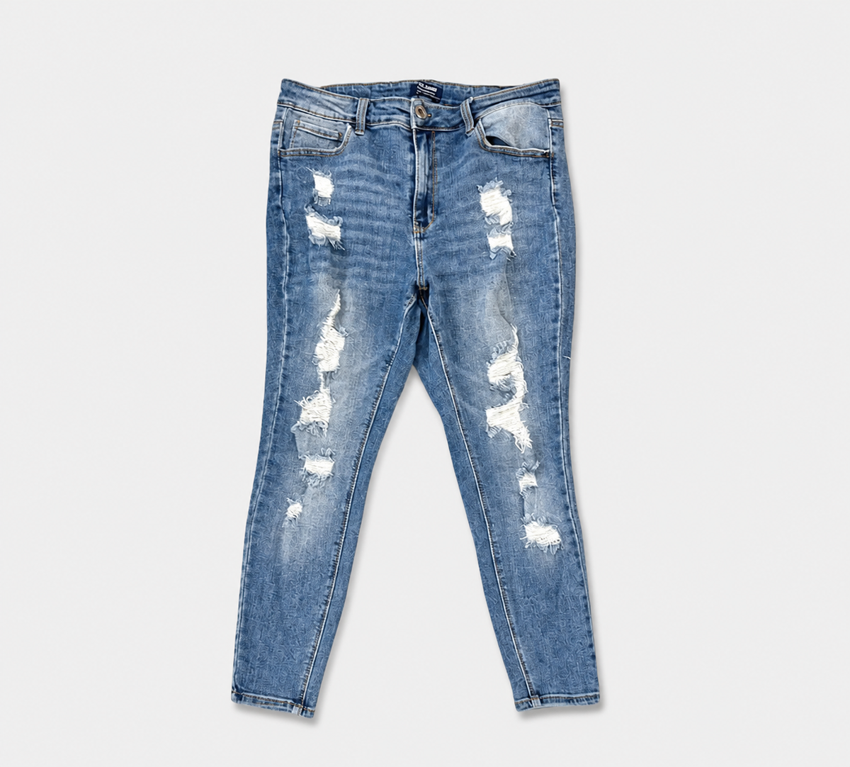 Light blue distressed skinny jeans with ripped details on the thighs and knees, shown flat against a light gray background.