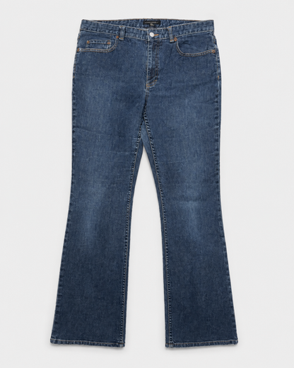 A pair of dark blue denim jeans with a straight-leg or bootcut fit, laid flat against a light gray background.