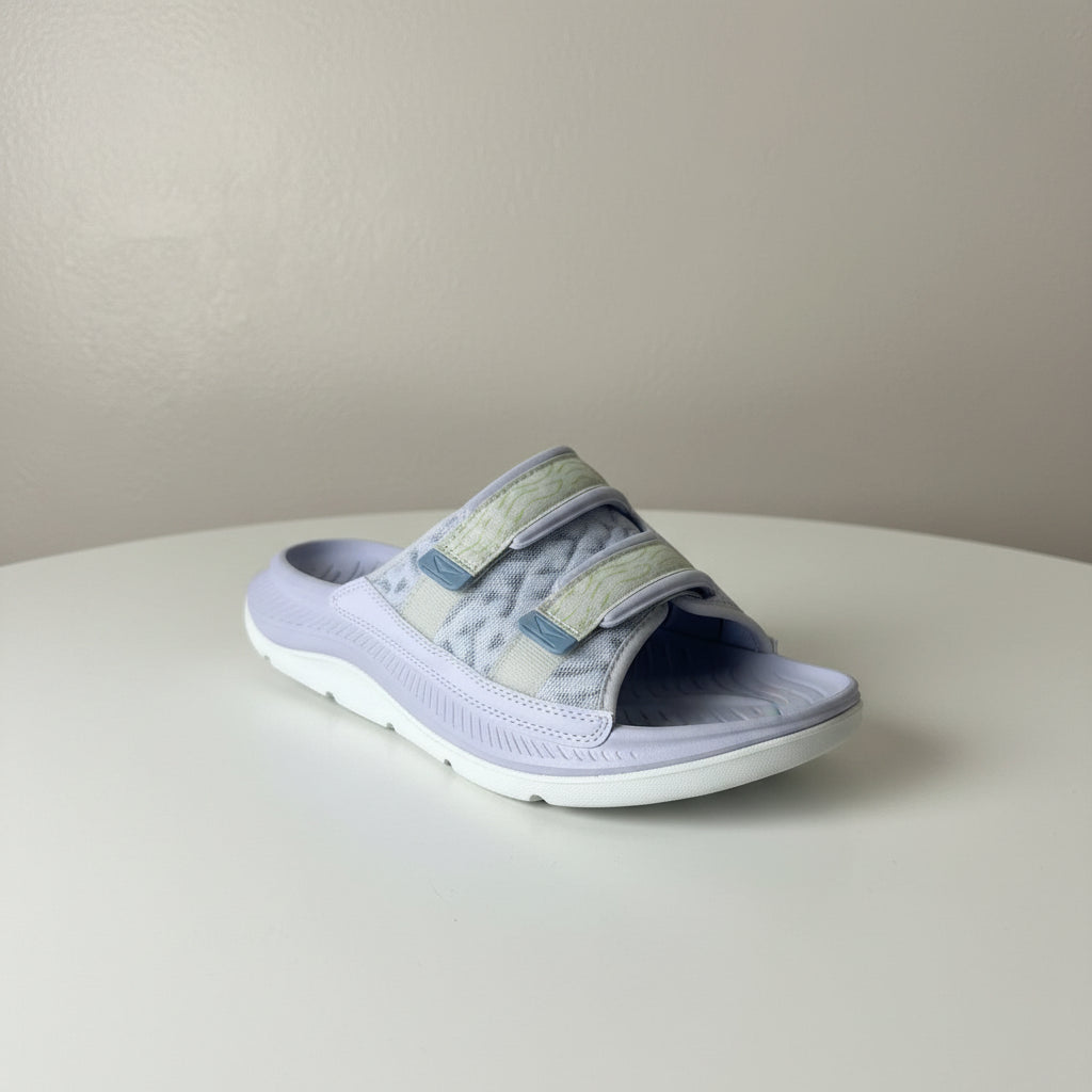 Pair of gray sandals with white soles on a plain background