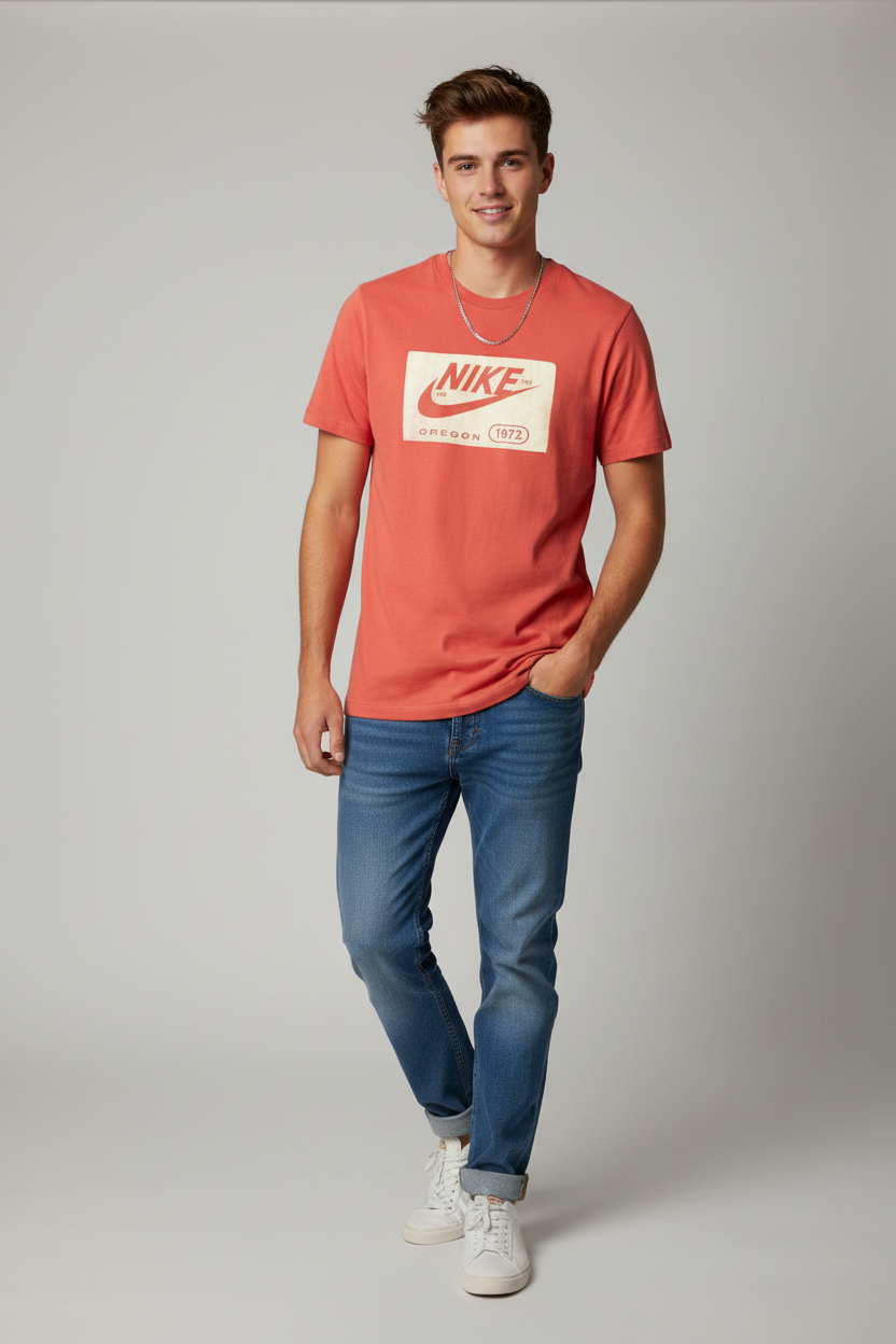 A faded red Nike short-sleeve t-shirt with a vintage-style cream graphic on the chest featuring the red swoosh and 'NIKE OREGON 1972' text, laid flat on a light gray background.