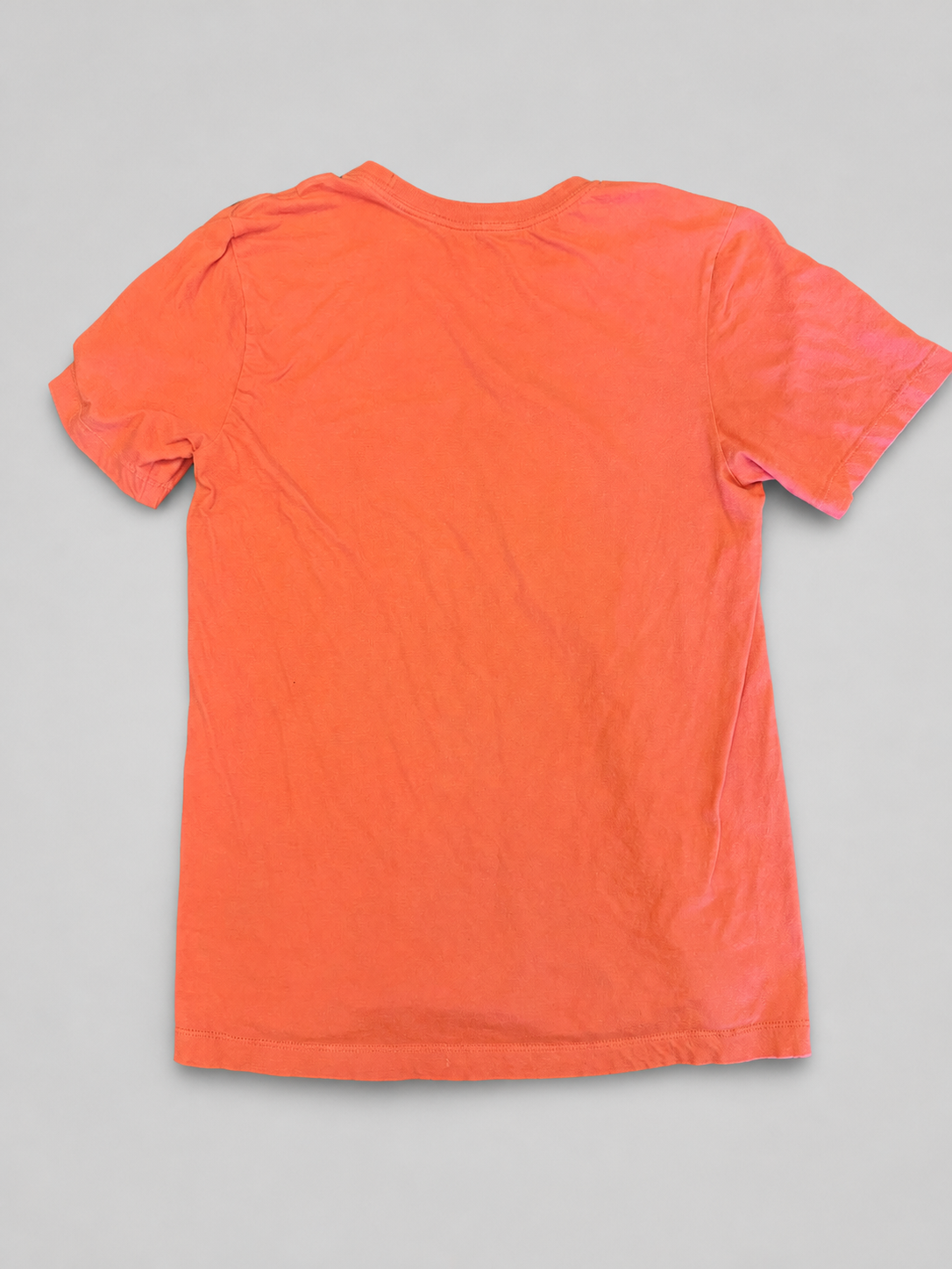A bright orange short-sleeve t-shirt shown from the back, laid flat against a neutral gray background.