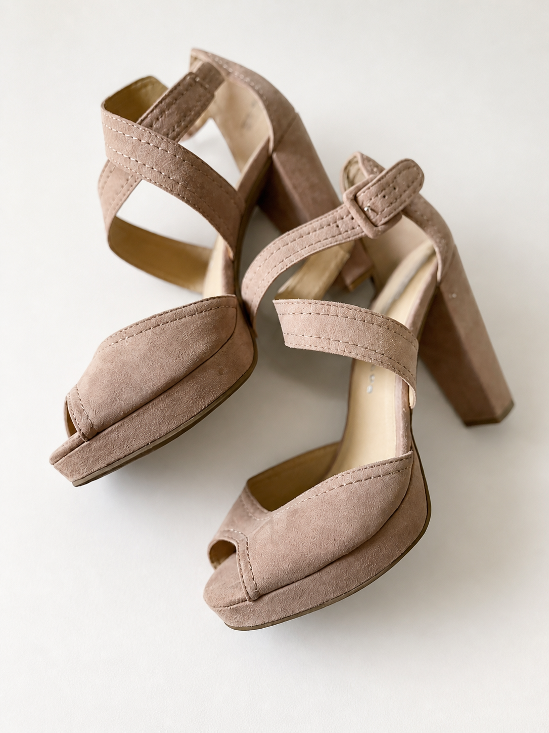 A pair of women's platform block-heel sandals in a dusty taupe suede-like material, featuring open toes, double crossover straps, and adjustable ankle straps, shown on a light off-white background.